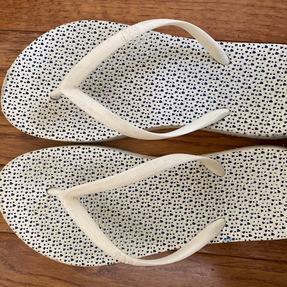 White with small black heart flip flops